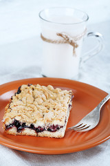 Homemade grated pie with jam and glass of milk