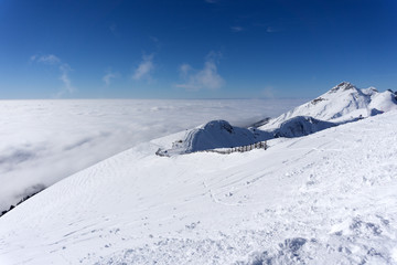 View on mountains and blue sky above clouds