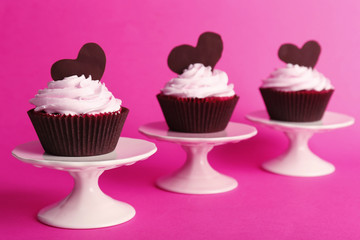 Delicious Valentine Day cupcakes on pink background