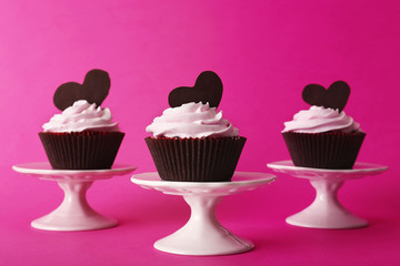 Delicious Valentine Day cupcakes on pink background