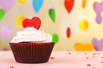 Delicious cupcake for Valentine Day on bright background