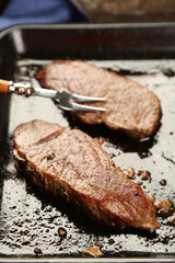 Composition with tasty roasted meat on pan, on wooden
