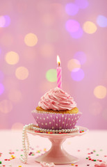 Delicious cupcake on table on bright background