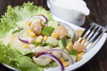 Salad with chicken meat, vegetables and pasta.