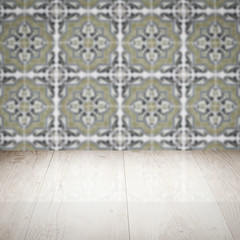 Wood table top and blur vintage ceramic tile pattern wall