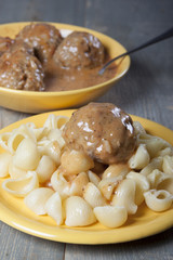 Meatballs with pasta with tomato sauce .