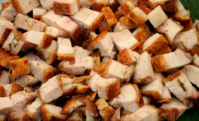 Crispy pork placed on a banana leaf