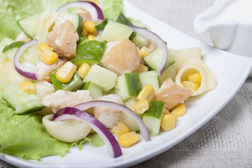 Salad with chicken meat, vegetables and pasta.