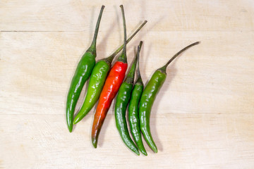 Red and green chili pepper on basket wood