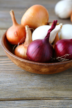 Onions in a wooden bowl