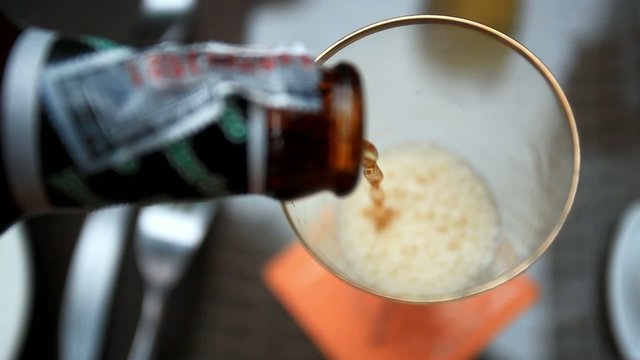 Pouring beer into a glass from bottle. HD. 1920x1080