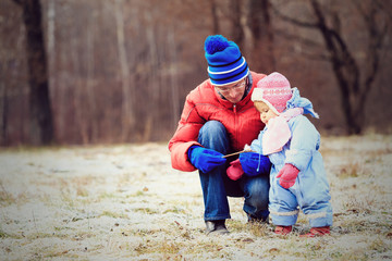 father and little daughter playing in winter