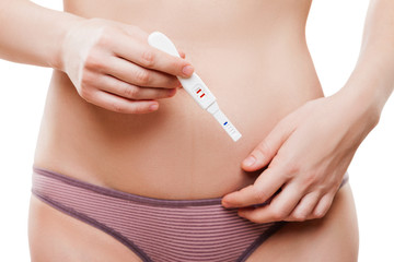 Beauty young woman hand holding pregnancy test showing two strip