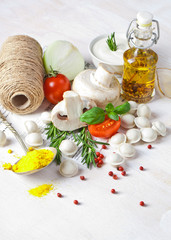 Tortellini and vegetables on white wooden background