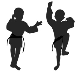 Silhouettes of two little boys who playing karate