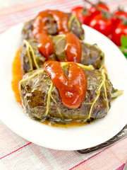 Rhubarb leaves stuffed with sauce in plate on tissue