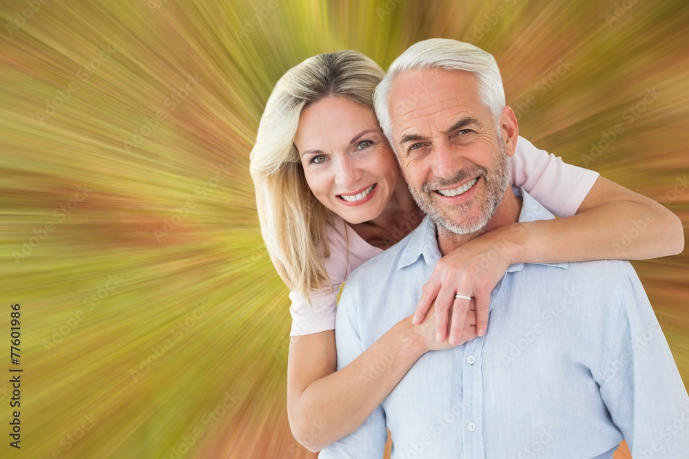 Poster smiling couple embracing and looking at camera