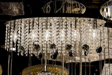Contemporary glass chandelier isolated over black background