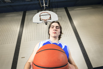 A teenager basketball player play his favorite sport