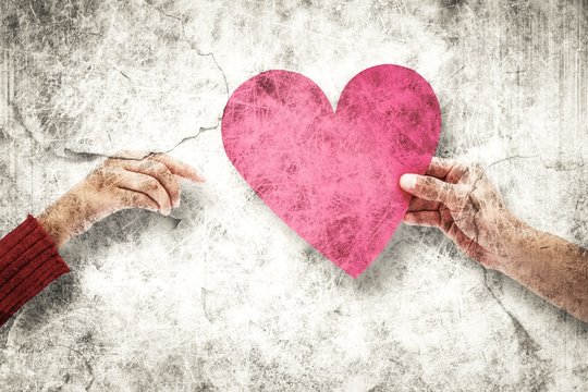 Composite image of couple holding a heart