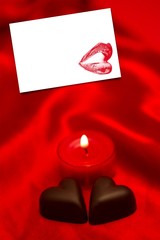 Composite image of chocolate hearts and lit candle