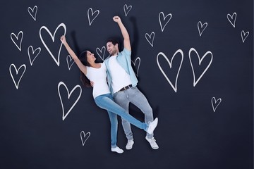 Composite image of happy casual couple cheering together