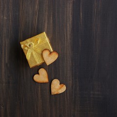 Wooden hearts on a present box