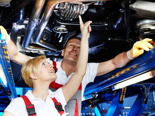 Mechanic inspecting the engine of a car