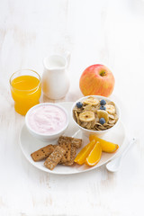 healthy breakfast - cereal, fruit, yogurt and juice, vertical