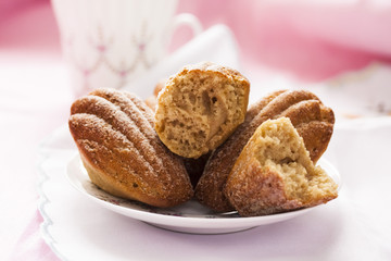 Madeleine with green tea on a pink background
