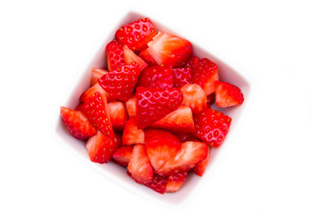 Square bowl of strawberries on white background top view