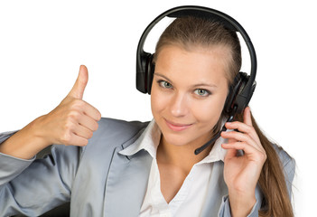 Businesswoman in headset showing thumb up