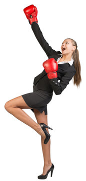 Businesswoman wearing boxing gloves