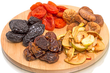 Dried fruits on kitchen board.