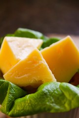 Cheese on a bed of lettuce in natural light