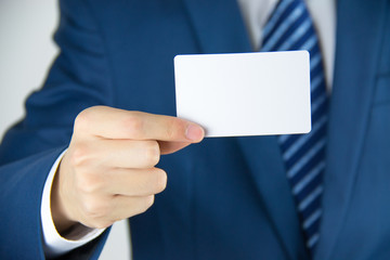 Man hand holding a business card