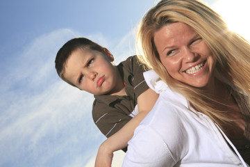 Fototapeta premium A portrait of a boy with is mother outside