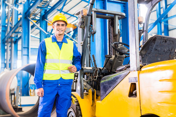 Forklift driver standing in manufacturing plant © Kzenon
