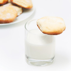 Sweet cookies with glass of milk on white