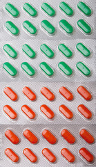 Vertical background of green and orange pills