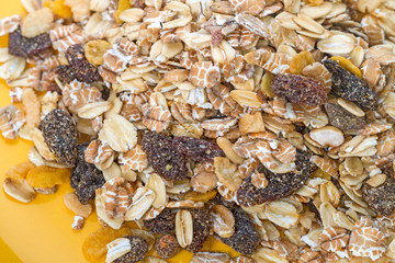 Muesli on a yellow plate