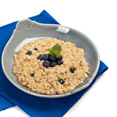 Porridge Oatmeal with fresh blueberries. Selective focus.