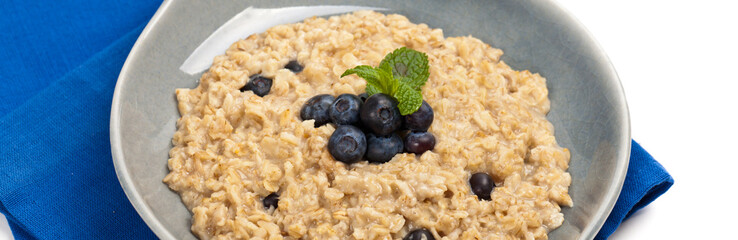 Porridge Oatmeal with fresh blueberries. Selective focus.