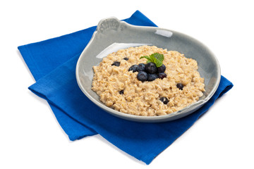 Porridge Oatmeal with fresh blueberries. Selective focus.