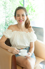 Portrait of beautiful young asian woman with coffee cup