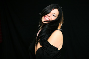 Young woman with straight hair on dark background