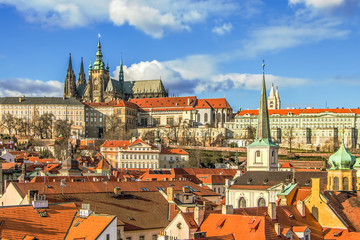 Fototapeta na wymiar View at Prague roofs and towers and Prague Castle