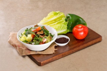 Plate of traditional Arabic salad fattouch on a wooden plate