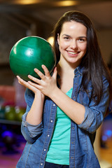 happy young woman holding ball in bowling club © Syda Productions