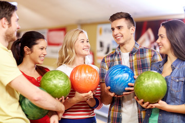 happy friends in bowling club